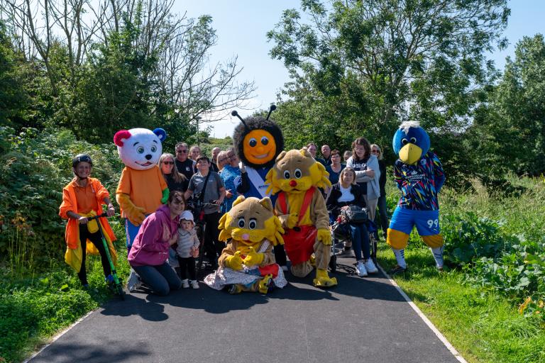 Walkers and mascots on walking and cycling path
