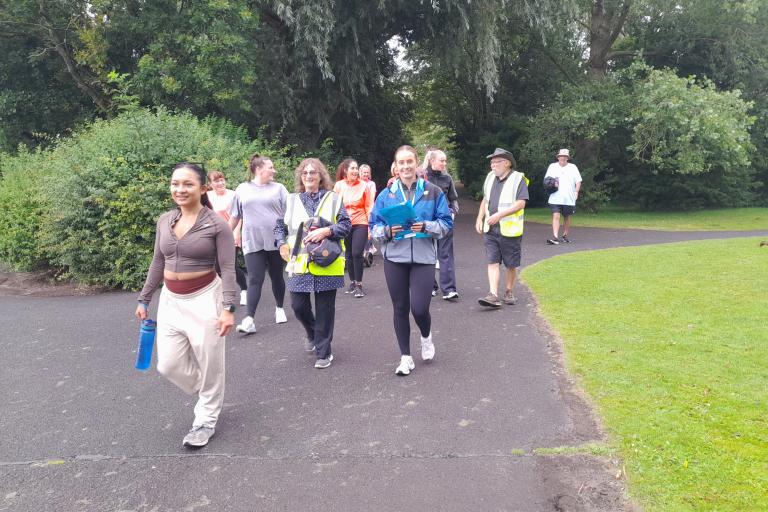 A group of adults walking in Barrow Park