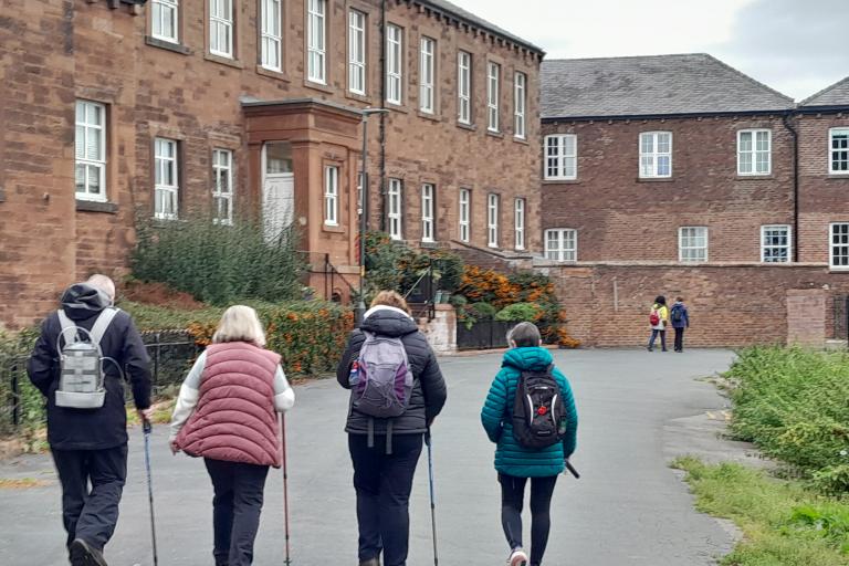 A group of adults walking outdoors in Carlisle 