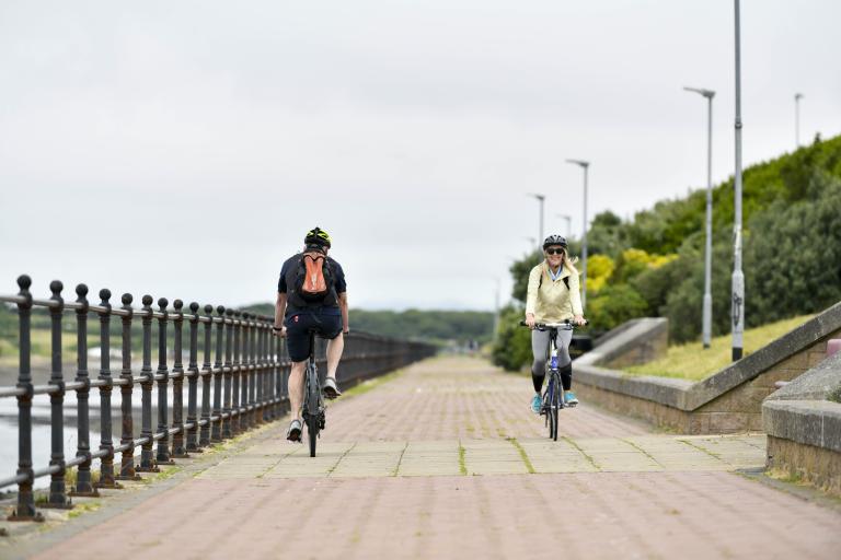 two people cycling along the channelside in Barrow