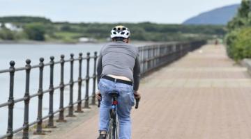 Man cycling down a path