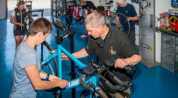 Man repairing a bike in a workshop
