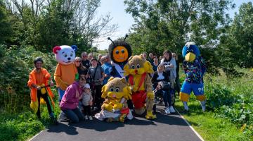 Walkers and mascots on walking and cycling path