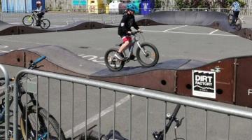 Child on a bike riding on a pump track