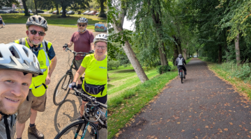 A montage of 2 images - one image shows a group of cyclists stood with bikes in a group wearing high vis jackets the second image shows a man riding a bike on a cycle path through trees