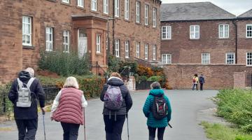A group of adults walking outdoors in Carlisle 