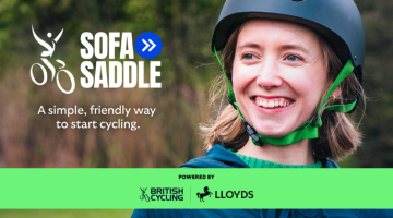 a girl wearing a cycling helmet smiling at the camera. Text displays British Cycling logo, Sofa to Saddle