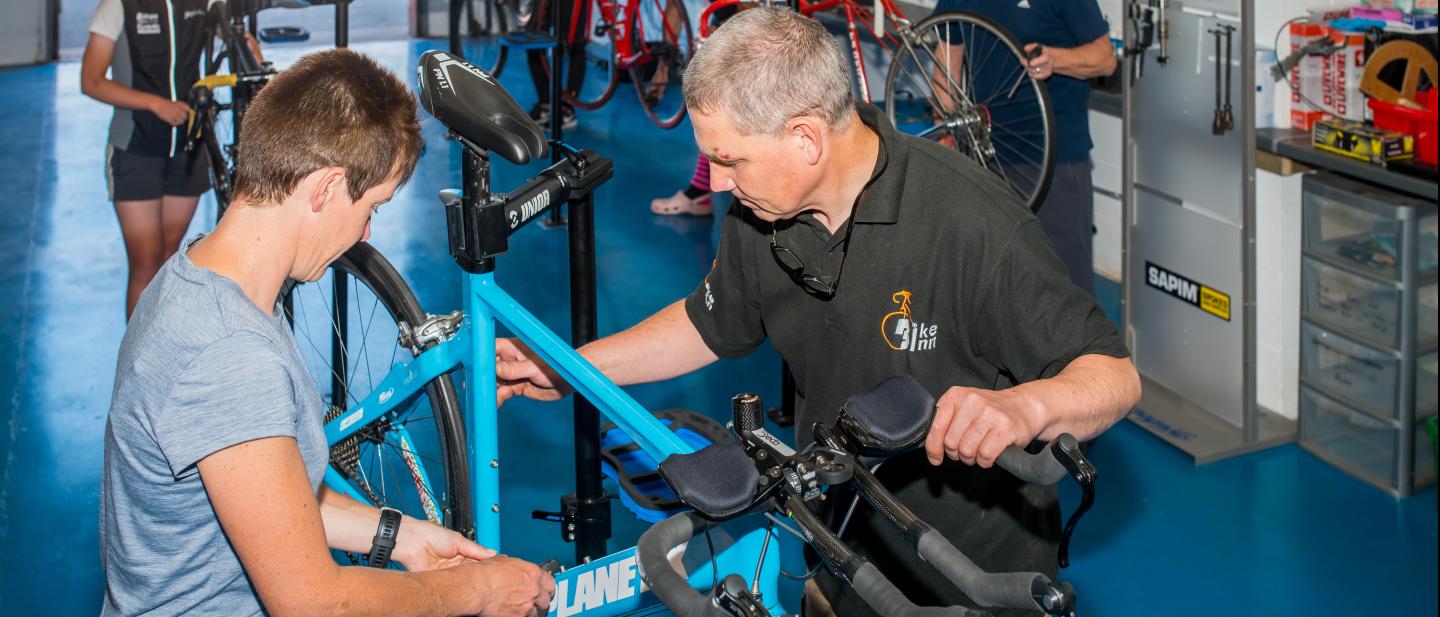 Man repairing a bike in a workshop